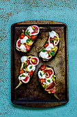 Baked eggplants with cherry tomatoes, figs, parsley and yogurt with chia seeds