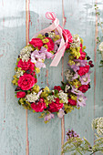 Hanging wreath of flowers of roses and shrubs