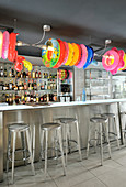 Colourful rubber rings above counter in bar