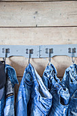 Denim clothing hung from hooks