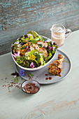 Garden salad with grilled chicken and edible flowers