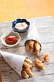 Breaded, fried chicken sticks with ketchup and mayonnaise