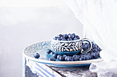 Bowl of fresh blueberries on blue plate