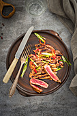 A grilled beefsteak sprinkled with chilli and spring onion