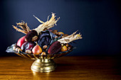 Autumnal fruit bowl with vegetables, corn on the cob and nuts