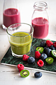 Red and green smoothies with berries