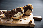 Two slices of vegan marble cake on a wooden board