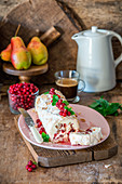 Cranberry and alomnd meringue roll with pears and cream