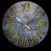 A clock with asparagus Roman numerals and cutlery hands