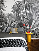 Wallpaper with jungle motif in black-and-white bedroom
