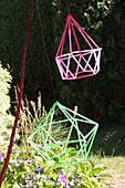 Geometric decoration made from colourful drinking straws in garden