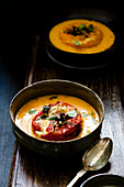 Yellow tomato soup with a grilled tomato