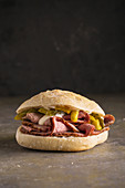 Delicious pastrami sandwich with pickles, mustard and mayo