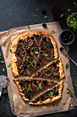 Pissaladiere pizza with onions, anchovies and greek basil
