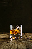 Glass of whiskey on a wooden table