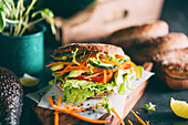 Vegetarian sandwich with lettuce, cucumber, carrot tomato anda avocado
