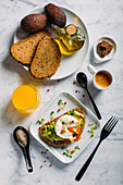 Brunch with coffee, orange juice and toast with avocado and boiled egg