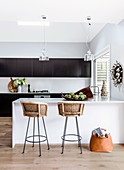Two bar stools on a modern kitchen in black and white