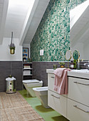 White washstand and green wallpaper in attic bathroom