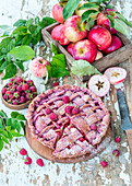 Apple pie with dried raspberry powder and raspberries