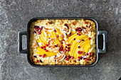 Coconut rice bake with mango, pomegranate seeds and coconut chips