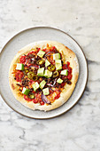 Pizza 'Mexico' with avocado, minced meat and jalapeños