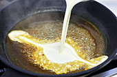 Cream being added to sauce