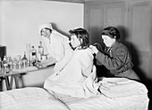 Red Cross doctor with refugee child, France