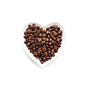 Coffee beans in heart shape bowl