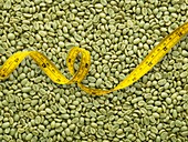Green coffee beans and tape measure