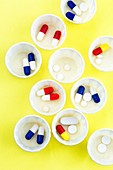 Pills in paper medicine pots