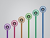 Multicoloured stethoscopes in a row