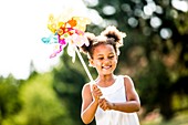 Girl holding paper windmill