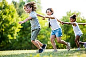 Children holding hands and running