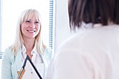 Female patient listening to doctor and smiling