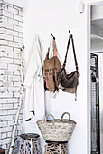 Wardrobe corner with wall hooks and stools with macrame decoration