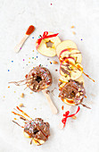 Caramelized Apple Slices on a Sticks with Nuts and Colored Sprinkles