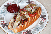 Steak with cheese, jalepenos and peppers in a hot dog roll
