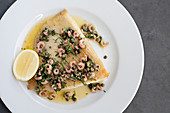 Skate wing with freshwater prawns, brownbutter, capers and a lemon wedge
