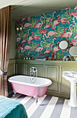 Flamingo-patterned wallpaper and wainscoting in bathroom
