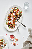 Beautiful chicken and lentil salad topped with yoghurt, almonds and pomegranates