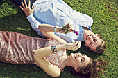 A young couple in love lying on a lawn