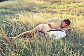 A young couple kissing in a field