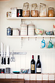 Storage jars and bowls on kitchen shelves