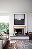 Seating with beige upholstered armchairs by the modern open fireplace