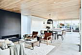 Modern living room with fireplace, dining area and open kitchen
