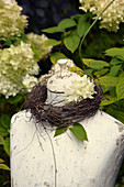 Wreath of wicker and hydrangea around neck of tailors' dummy