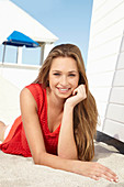 A young blonde woman wearing a red dress