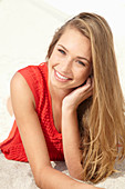 A young blonde woman wearing a red dress