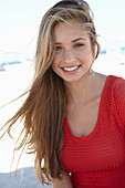 A young blonde woman wearing a red dress